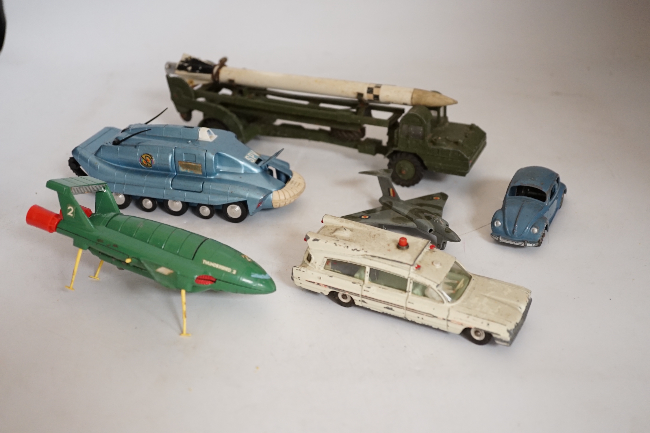 Twenty-two Dinky Toys mostly for restoration, including a Car Carrier (984), Missile Erector, Missile Servicing Platform, Spectrum Pursuit Vehicle, Thunderbird 2 containing Thunderbird 4, Rolls-Royce Silver Wraith, etc.